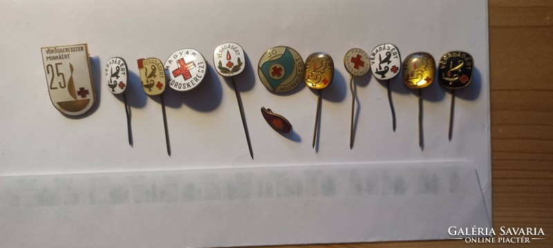 12 red cross badges/pins in one