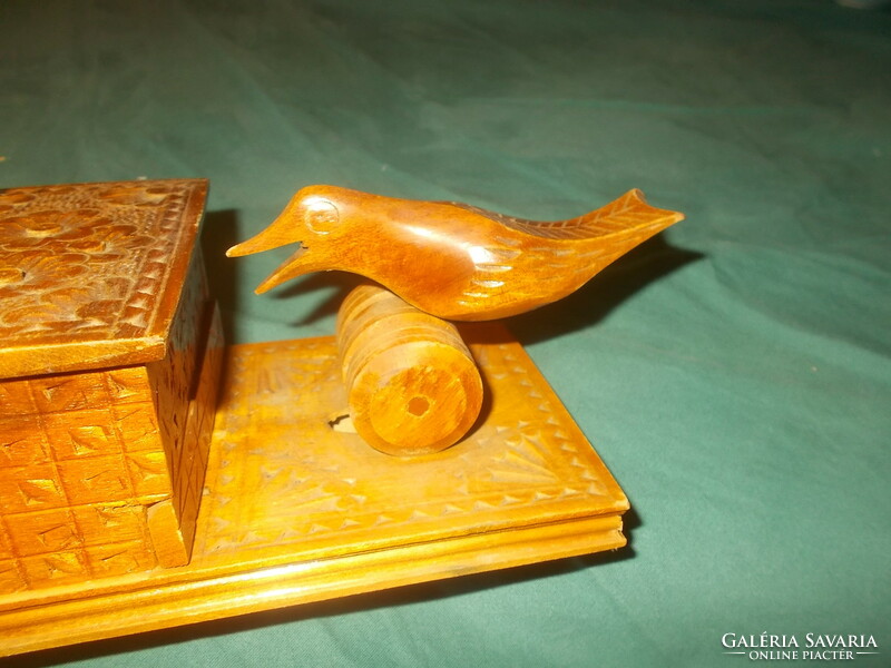 Old carved wooden cigarette holder with birds