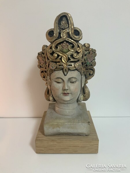 Hand-painted concrete Buddha head, statue on a wooden plinth