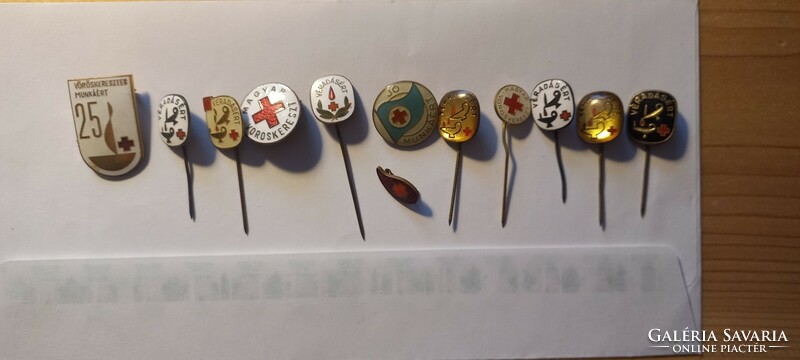 12 red cross badges/pins in one