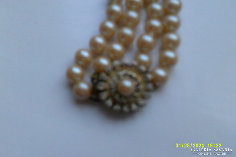 Two rows of antique pearls with decorative clasp.