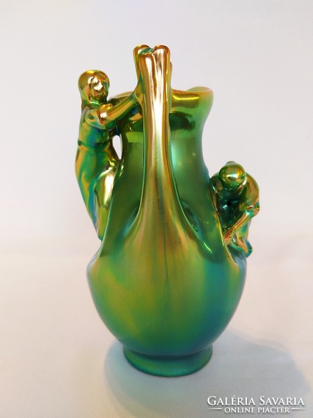 Zsolnay is a girl sitting on an eosin jar, in gold-green eosin color. Flawless!