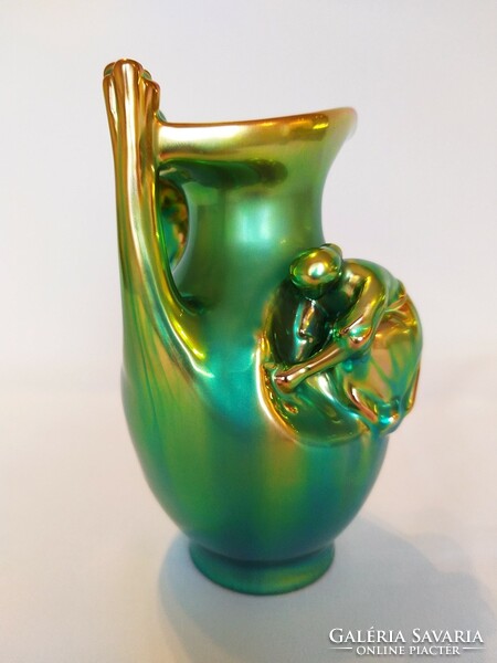 Zsolnay is a girl sitting on an eosin jar, in gold-green eosin color. Flawless!