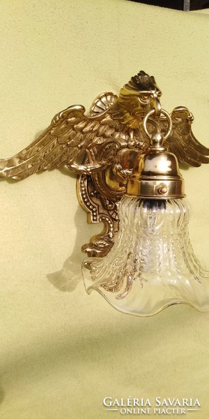 A large wall arm decorated with an eagle is for sale.