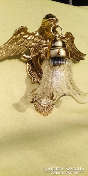 A large wall arm decorated with an eagle is for sale.