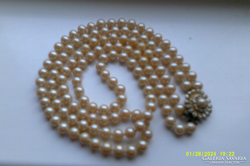 Two rows of antique pearls with decorative clasp.