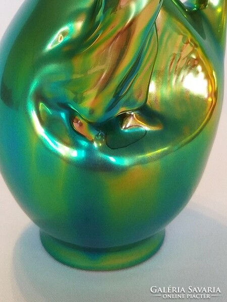 Zsolnay is a girl sitting on an eosin jar, in gold-green eosin color. Flawless!
