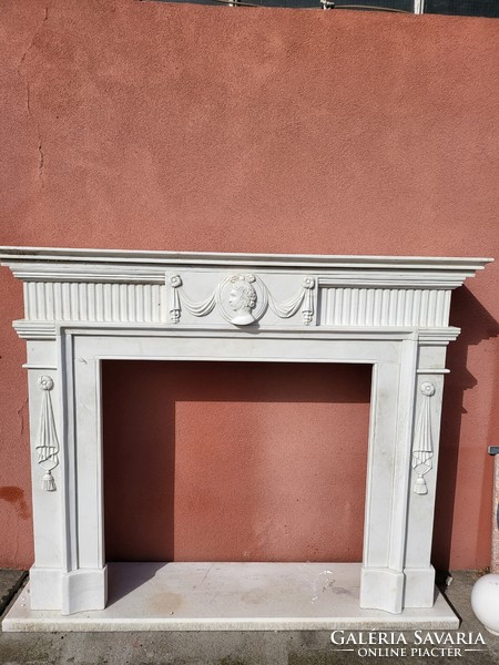 Classic marble fireplace with an antique portrait