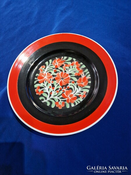 Hollóháza porcelain wall decorative plate painted red and black with a flower pattern in the middle