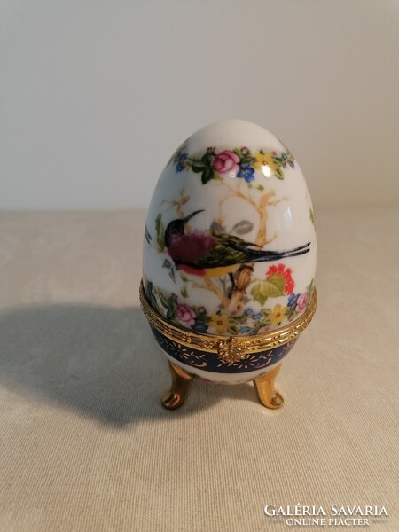 Wooden egg-shaped porcelain jewelry holder with a hinged lid.