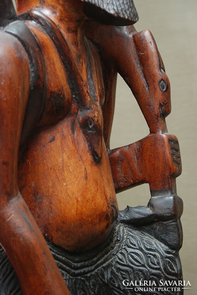 An exotic wooden statue depicting a Congolese hunter from Africa