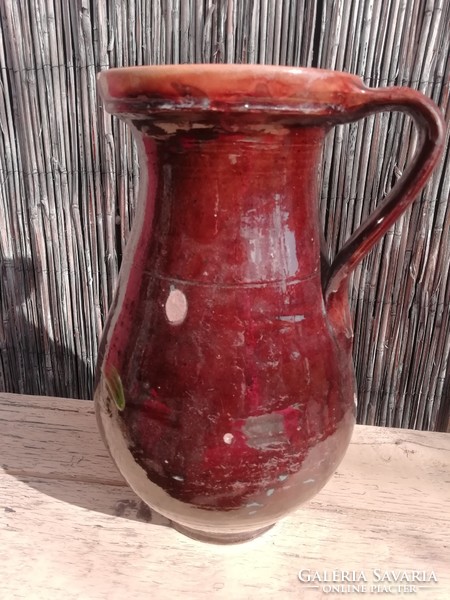 Old brown jug with floral pattern