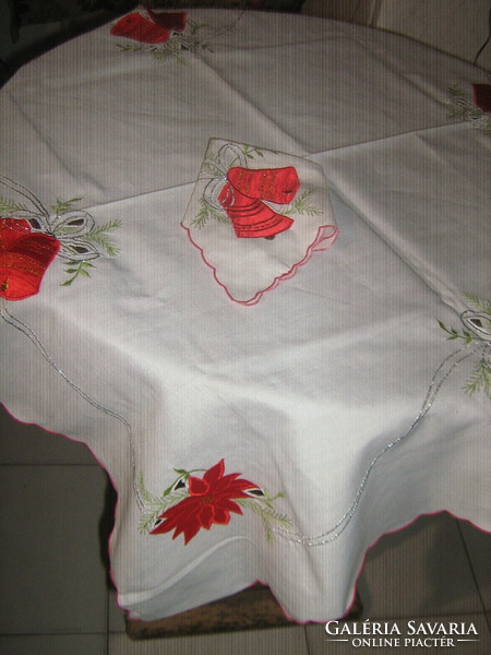 A charming Christmas tablecloth with sewn decorative floral bells and a star-shaped napkin