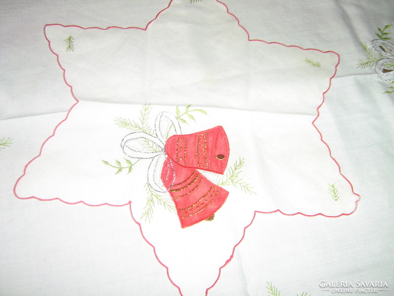 A charming Christmas tablecloth with sewn decorative floral bells and a star-shaped napkin