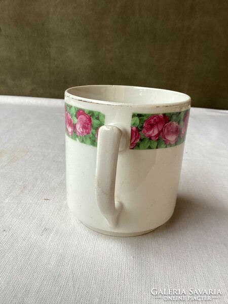 Old porcelain mug with rose pattern.