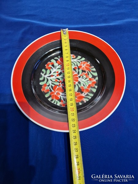 Hollóháza porcelain wall decorative plate painted red and black with a flower pattern in the middle
