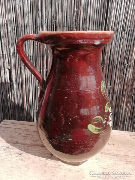 Old brown jug with floral pattern