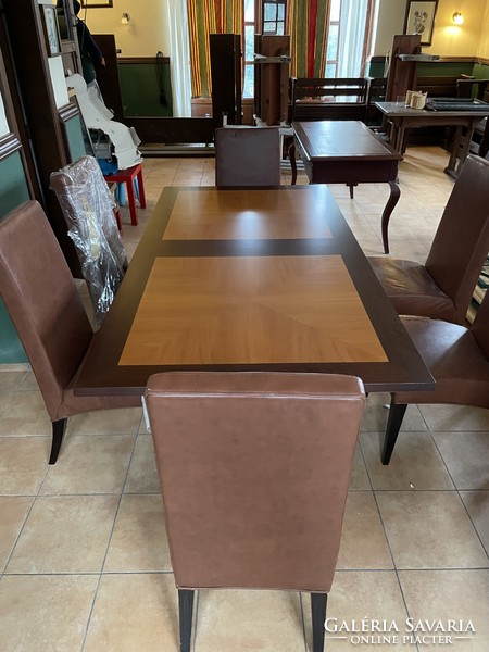 Mahogany and cherry wood table with brown leather chairs