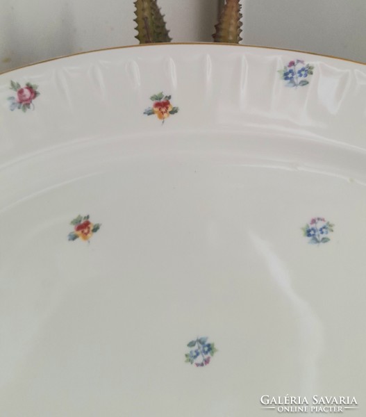 A large epiag serving bowl with a small flower pattern