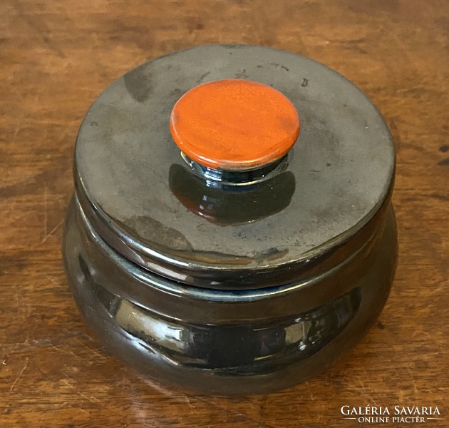 Gray round ceramic lidded jewelry holder bowl with orange tongs