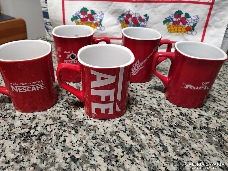 Red coffee mugs with Nescafé inscription