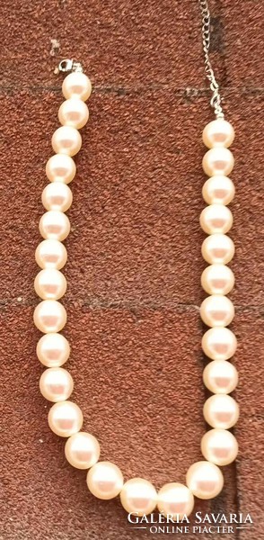 Clair's white pearl string necklace with large eyes