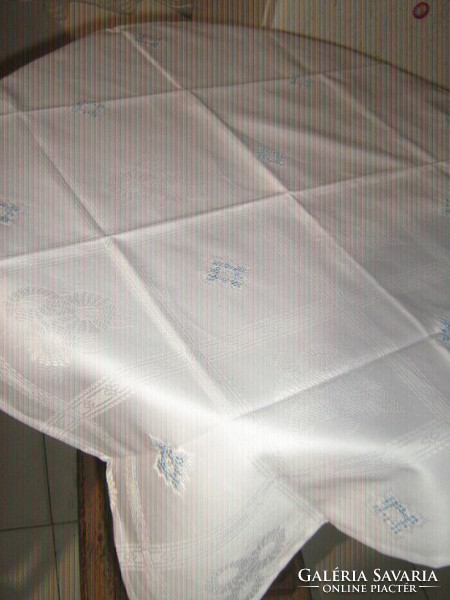 Elegant damask tablecloth embroidered with beautiful snow-white blue crosses