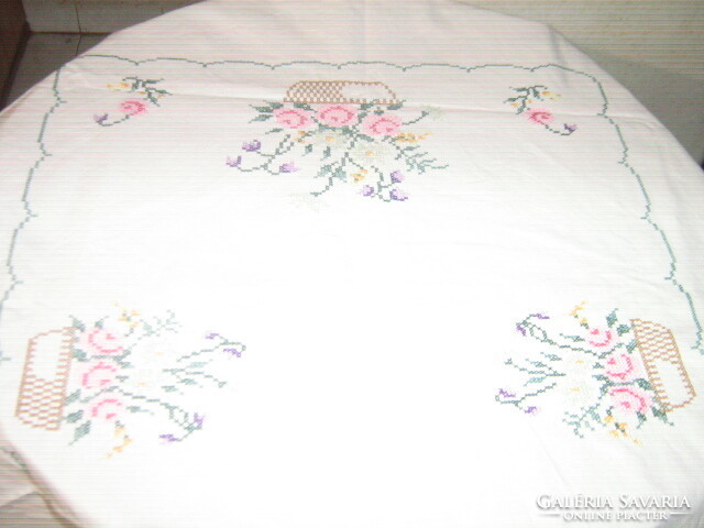 Beautiful floral oval tablecloth with a lace edge embroidered with small cross stitches