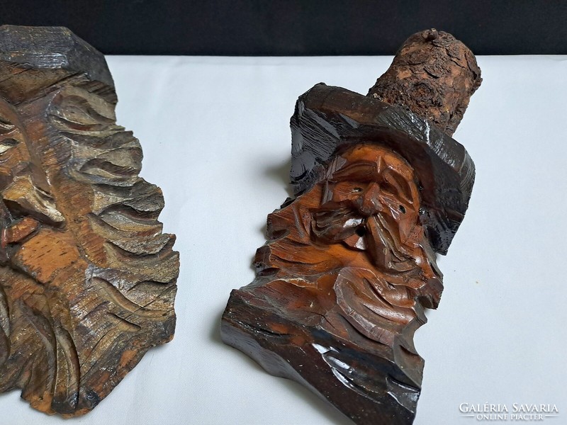 2 antique, hand-carved wooden human heads from a block that can be hung on the wall, relief