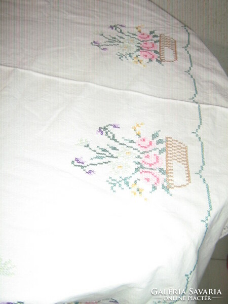 Beautiful floral oval tablecloth with a lace edge embroidered with small cross stitches