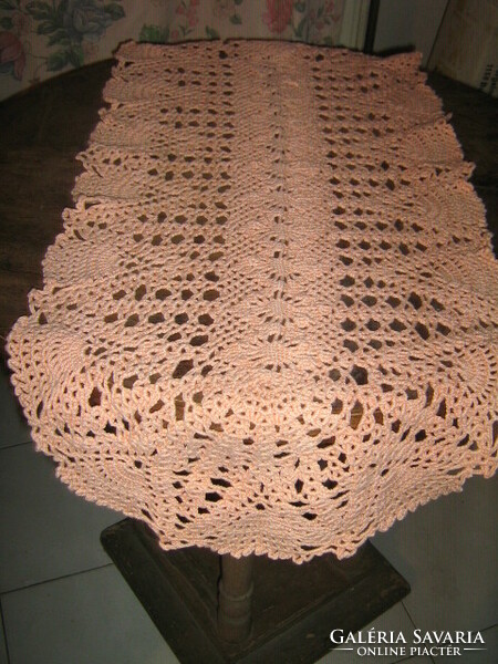 Wonderful antique handmade crochet salmon on pink needlework tablecloth