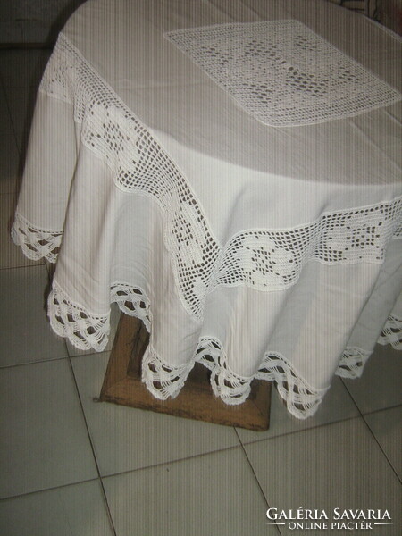 Beautiful white hand-crocheted round tablecloth with a crocheted flower insert