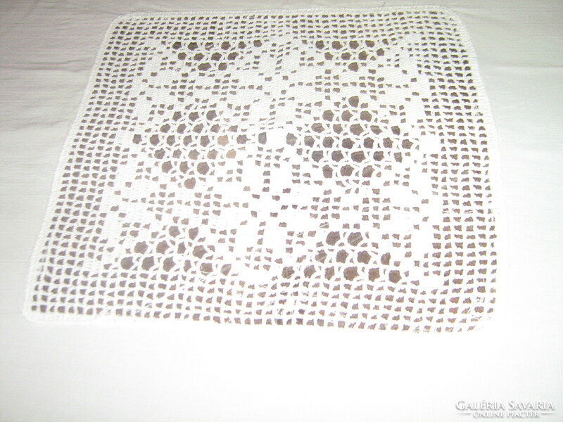 Beautiful white hand-crocheted round tablecloth with a crocheted flower insert