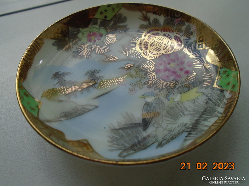 Antique hand-painted, gold-contoured eggshell porcelain Japanese bowl with a pair of birds and a flower pattern