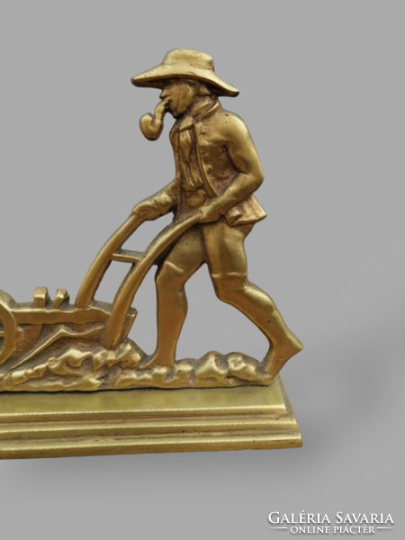 Plowing worker copper statue