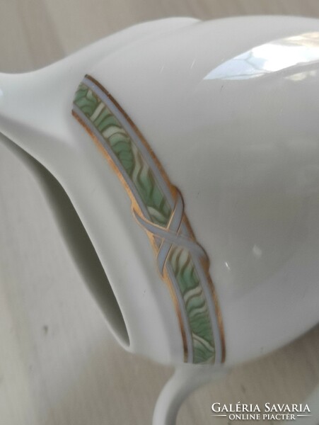 Graceful porcelain cream with a flowing green-gold Art Nouveau pattern