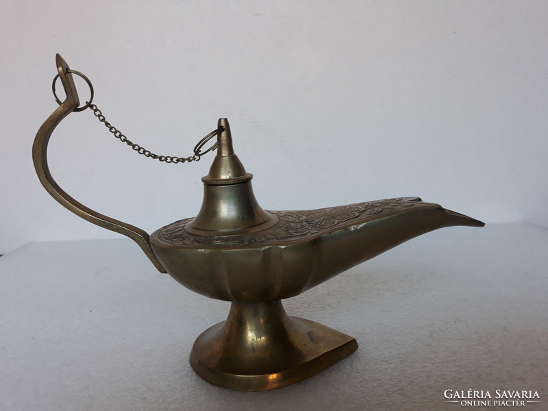 Old portable patinated copper oil lamp with candle, antique style