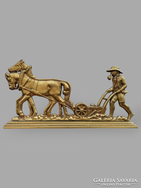 Plowing worker copper statue