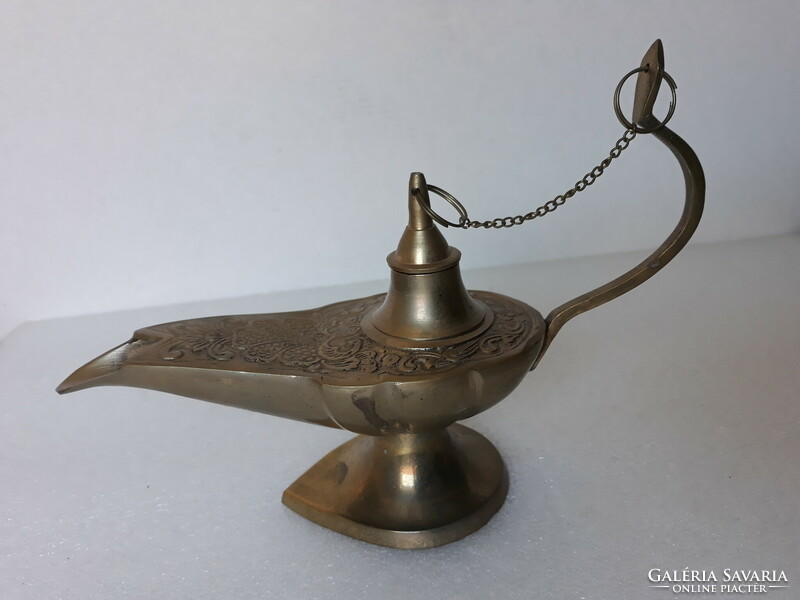 Old portable patinated copper oil lamp with candle, antique style