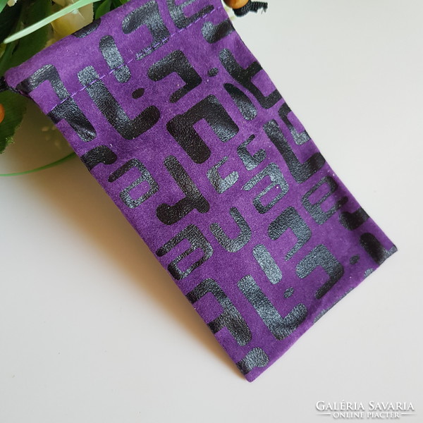 New retro textile phone case with a black pattern on a purple background with a cord that can be hung around the neck
