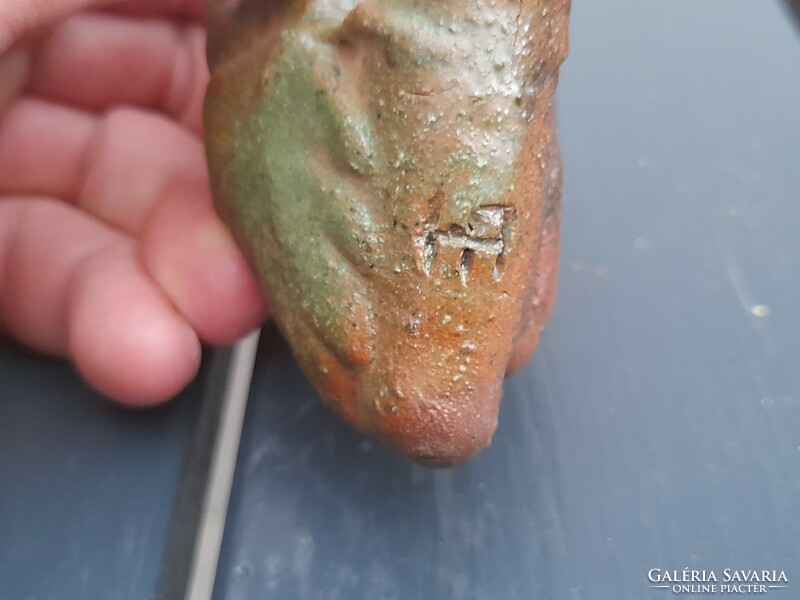 A very old hard earthenware pipe marked with a reed stem