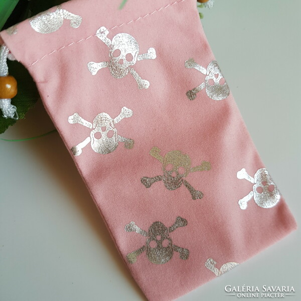 New retro textile phone case with a silver skull pattern on a pink background with a cord that can be hung around the neck