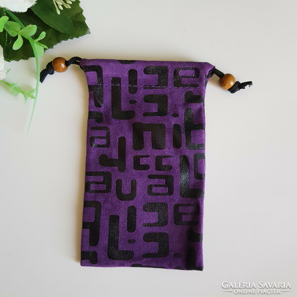 New retro textile phone case with a black pattern on a purple background with a cord that can be hung around the neck