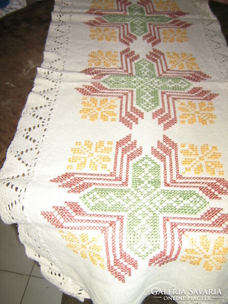Antique woven tablecloth with a lace edge embroidered with a beautiful cross stitch