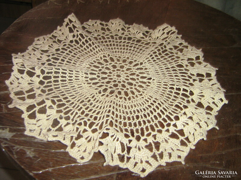 Beautiful beige hand-crocheted round lace tablecloth