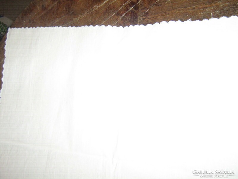 Beautiful white linen tablecloth with ruffled flowers