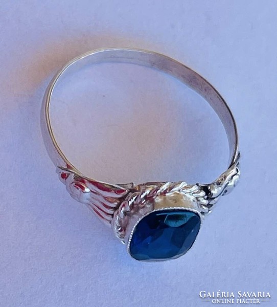 Silver ring with dark blue topaz stone.