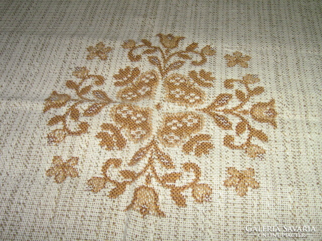 Beautiful boy-girl on a woven tablecloth with Bavarian folk motifs