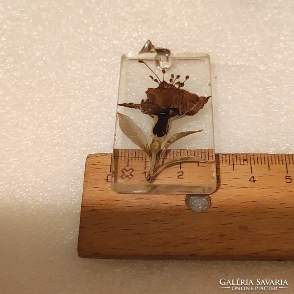 Plastic pendant with dried flowers