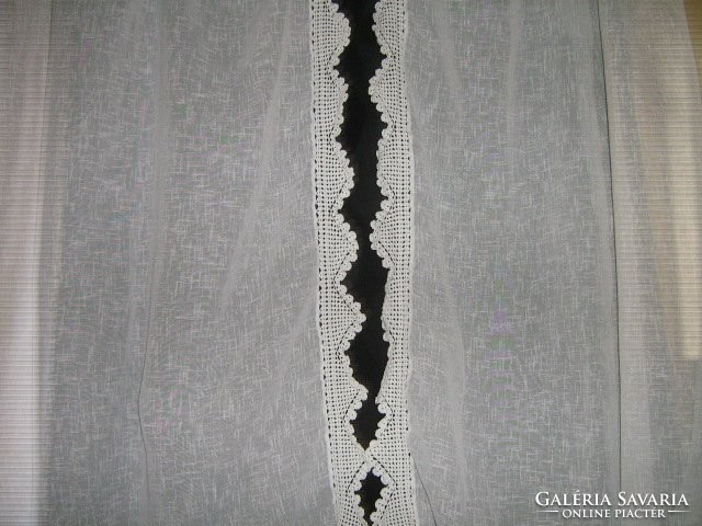 A beautiful pair of curtains with hand-crocheted edges